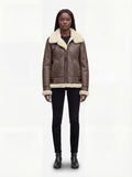 Female model wearing Maverick Paige shearling aviator jacket, relaxed fit, styled with black skinny jeans and black leather ankle boots. Maverick Paige.