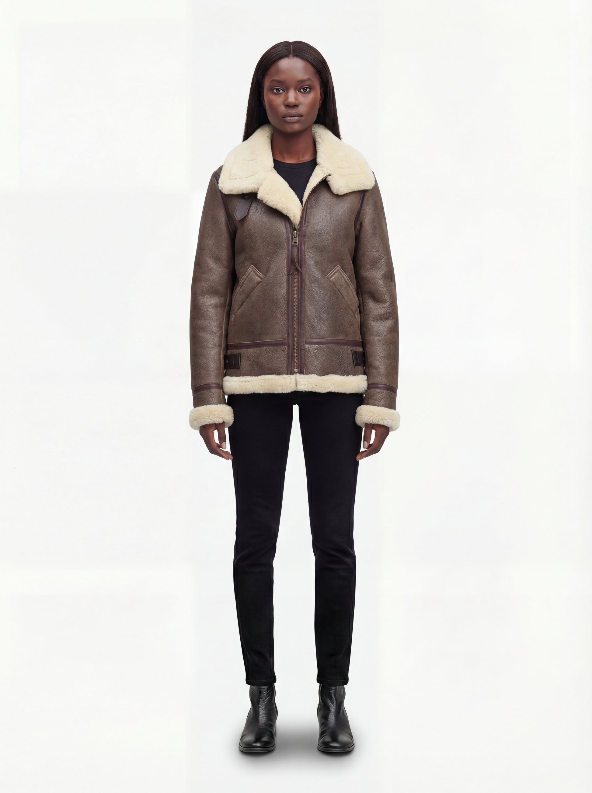 Female model wearing Maverick Paige shearling aviator jacket, relaxed fit, styled with black skinny jeans and black leather ankle boots. Maverick Paige.