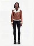 Female model wearing Maverick Fallon tan shearling biker jacket, tailored fit, styled with black skinny jeans and black leather boots. Maverick Fallon.