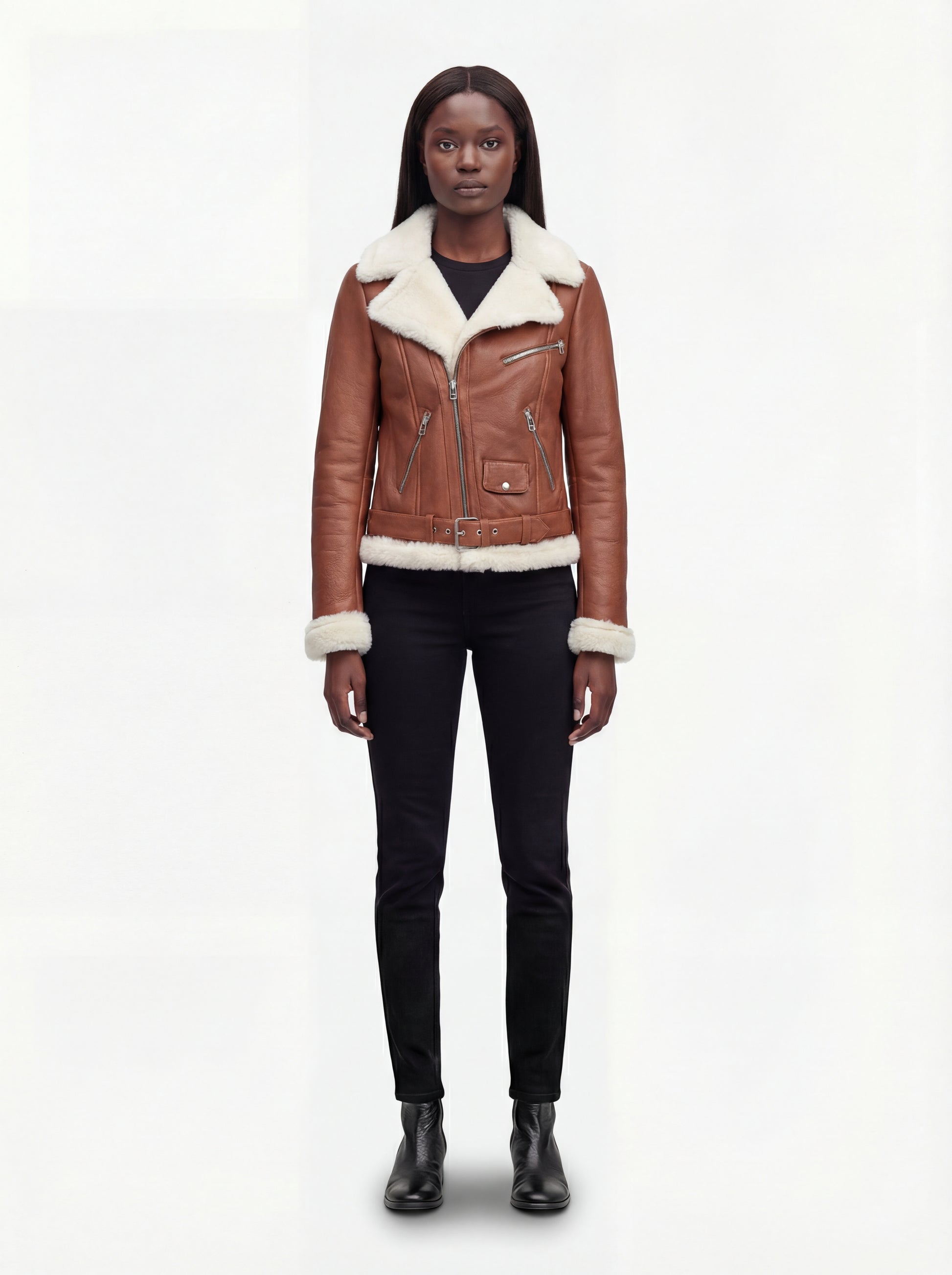 Female model wearing Maverick Fallon tan shearling biker jacket, tailored fit, styled with black skinny jeans and black leather boots. Maverick Fallon.