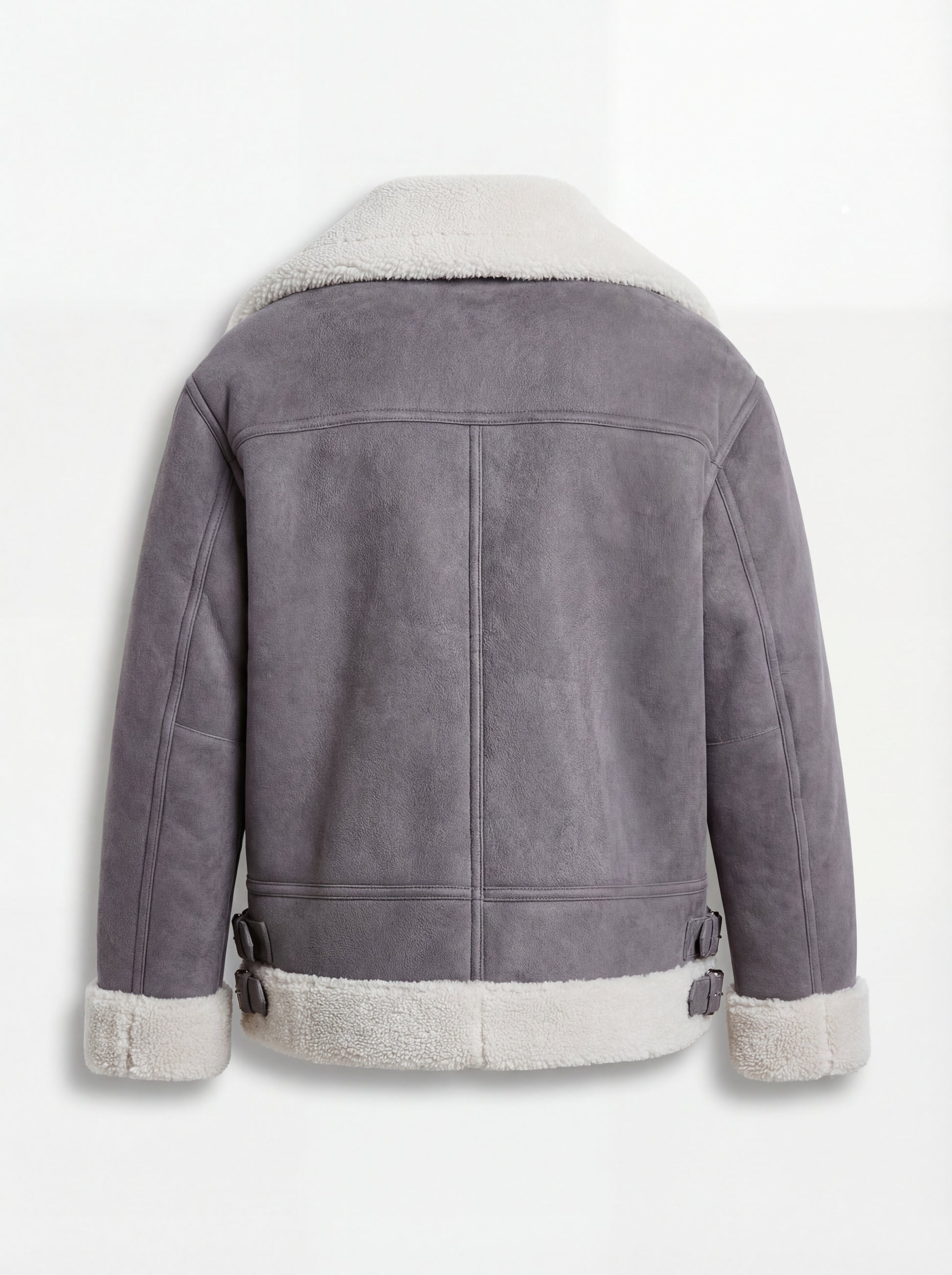 Rear view of grey suede shearling aviator jacket showing vertical center seam and buckled side waist tabs. Maverick Esme.