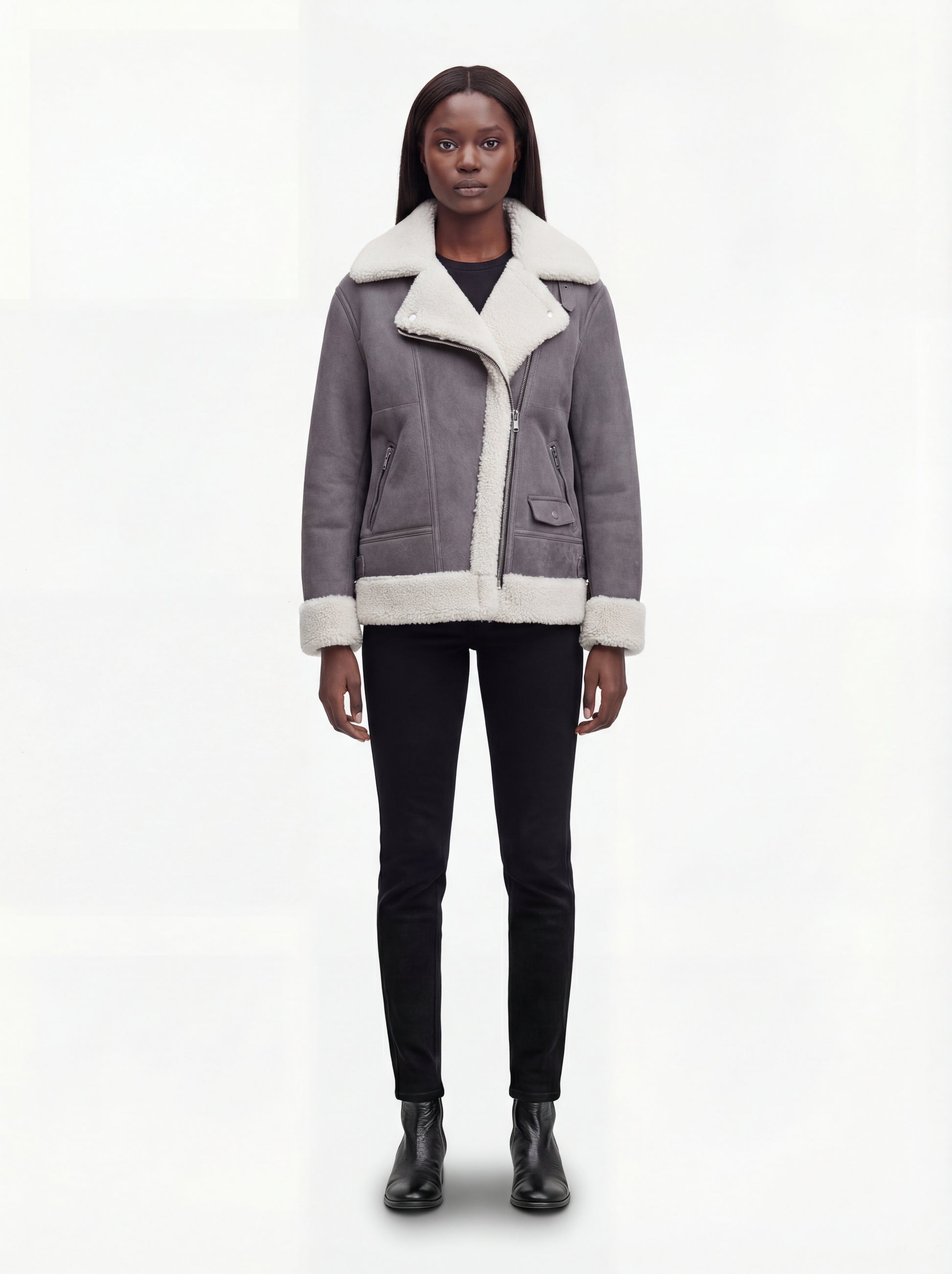 Female model wearing Maverick Esme shearling aviator jacket, relaxed fit, styled with black skinny jeans and black leather ankle boots. Maverick Esme.