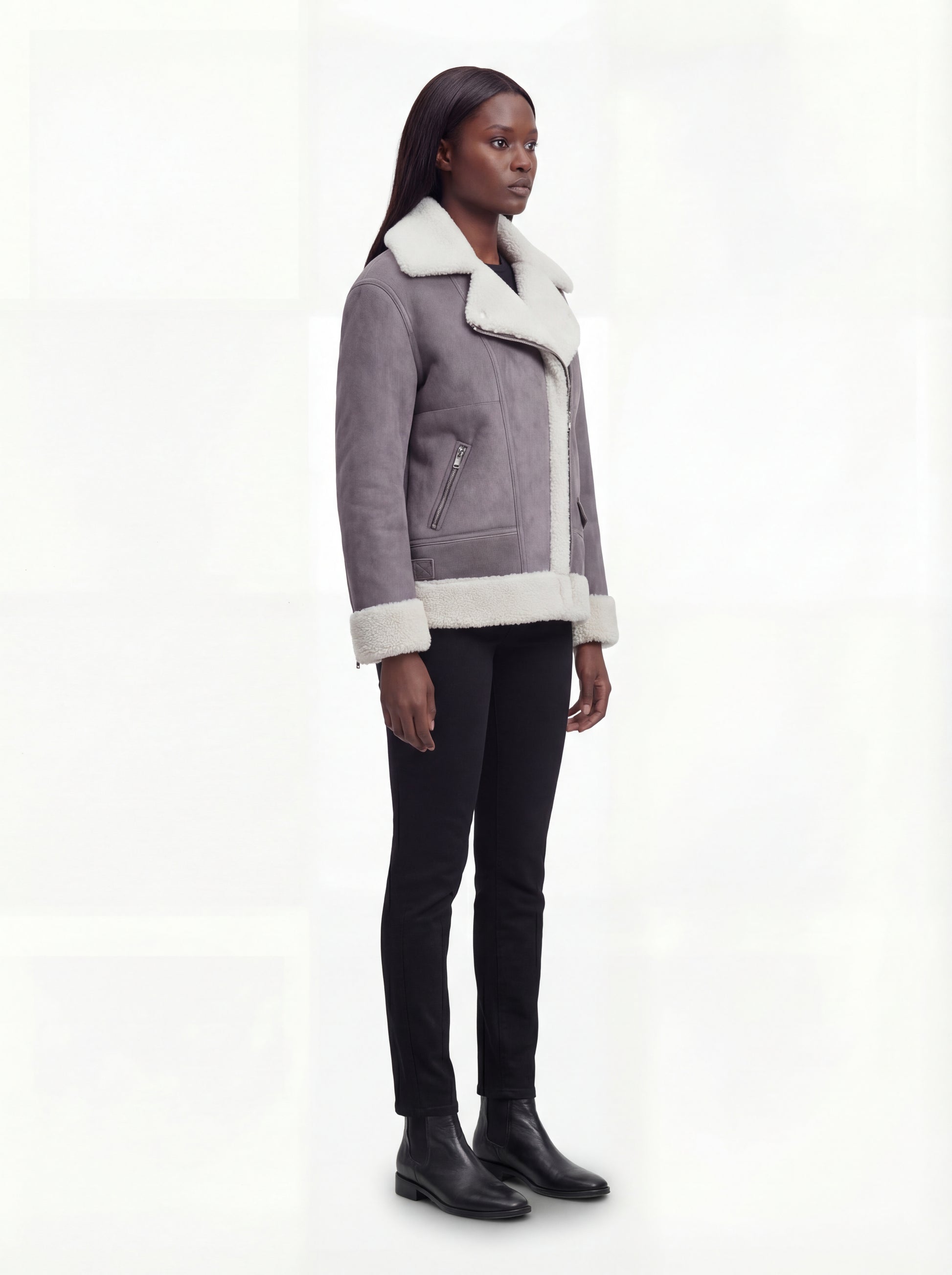 Side profile of Maverick Esme aviator jacket showing thick shearling cuffs and boxy hip-length silhouette. Maverick Esme.