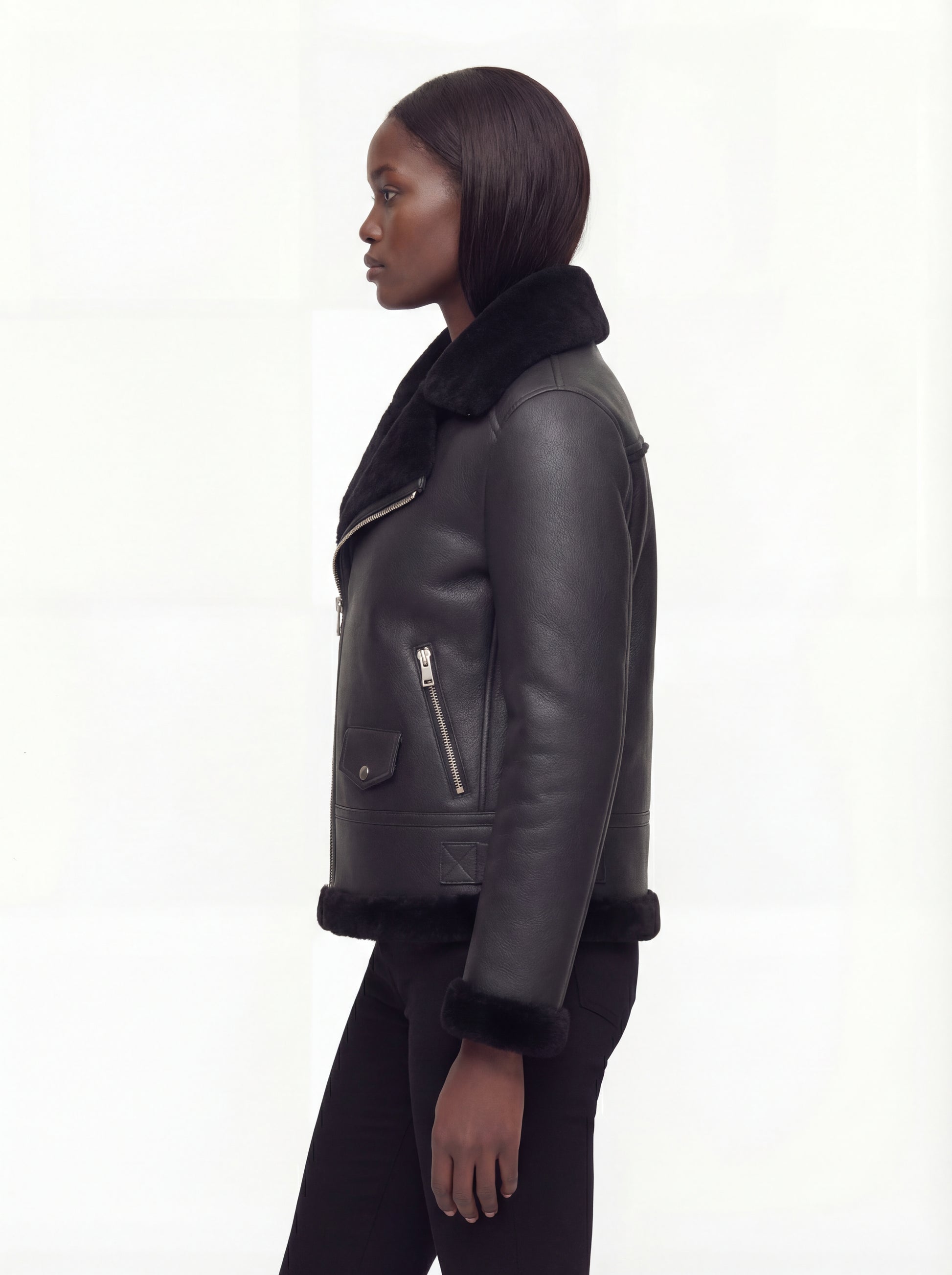 Side profile of Maverick Nova aviator jacket showing thick shearling cuffs and hip-length silhouette. Maverick Nova.