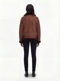 Rear view of female model wearing Maverick Eliza aviator jacket showing structured shoulder fit and hem buckle details. Maverick Jacket.