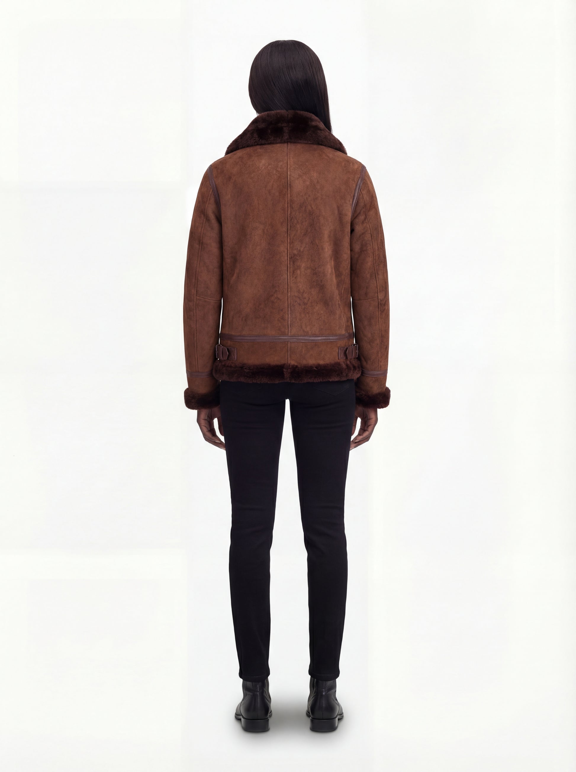 Rear view of female model wearing Maverick Eliza aviator jacket showing structured shoulder fit and hem buckle details. Maverick Jacket.