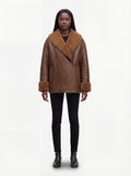 Female model wearing Maverick Greta oversized shearling jacket, relaxed fit, styled with black skinny jeans and black Chelsea boots. Maverick Greta.