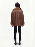 Rear view of female model wearing Maverick Greta shearling jacket showing dropped shoulder fit and whipstitch back detailing. Maverick Greta.