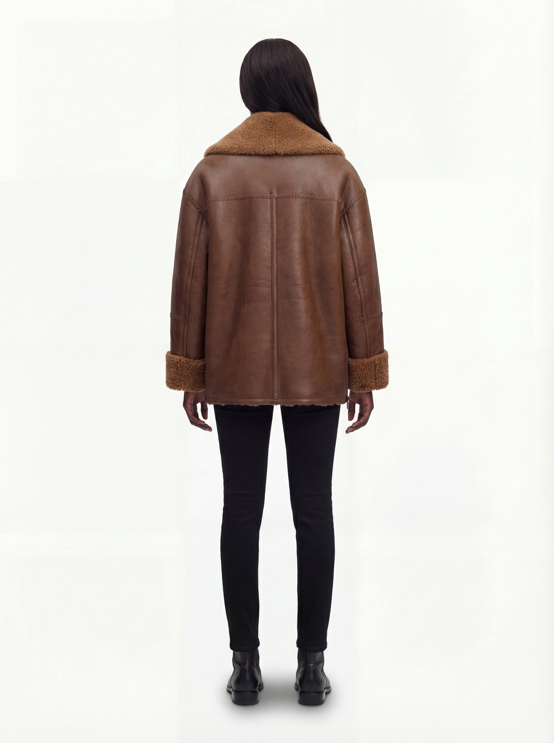 Rear view of female model wearing Maverick Greta shearling jacket showing dropped shoulder fit and whipstitch back detailing. Maverick Greta.