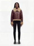 Female model wearing Maverick Faye shearling jacket, boxy fit, styled with black skinny jeans and black leather boots. Maverick Faye.
