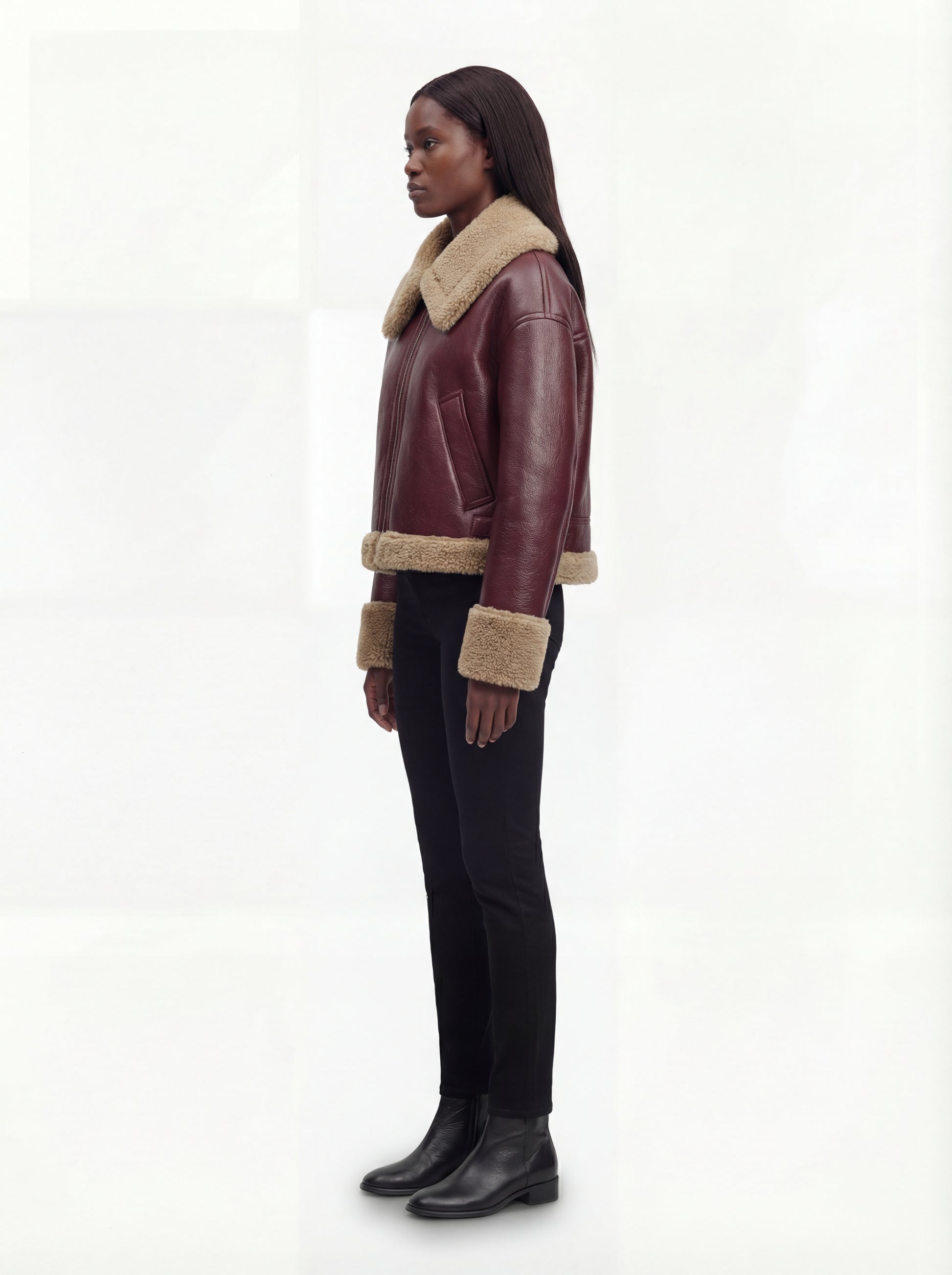 Side profile of Maverick Faye shearling jacket showing shearling cuff detail and boxy hip-length silhouette. Maverick Faye.