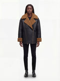 Female model wearing Maverick Noa shearling jacket, relaxed fit, styled with black skinny jeans and black leather ankle boots. Maverick Noa.