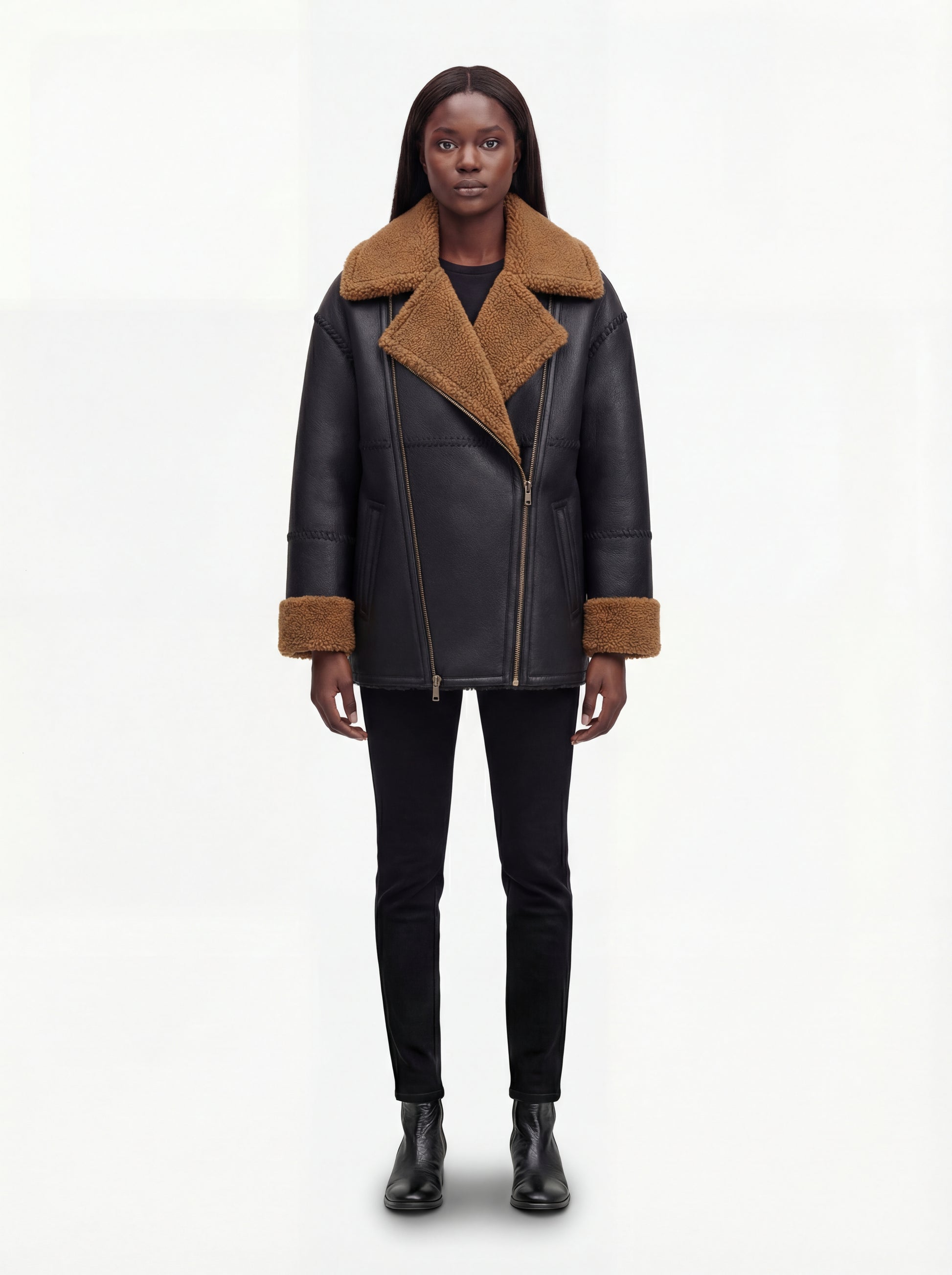 Female model wearing Maverick Noa shearling jacket, relaxed fit, styled with black skinny jeans and black leather ankle boots. Maverick Noa.