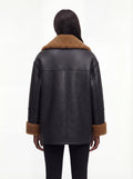 Rear view of female model wearing Maverick Noa shearling jacket showing dropped shoulders and straight back paneling. Maverick Noa.
