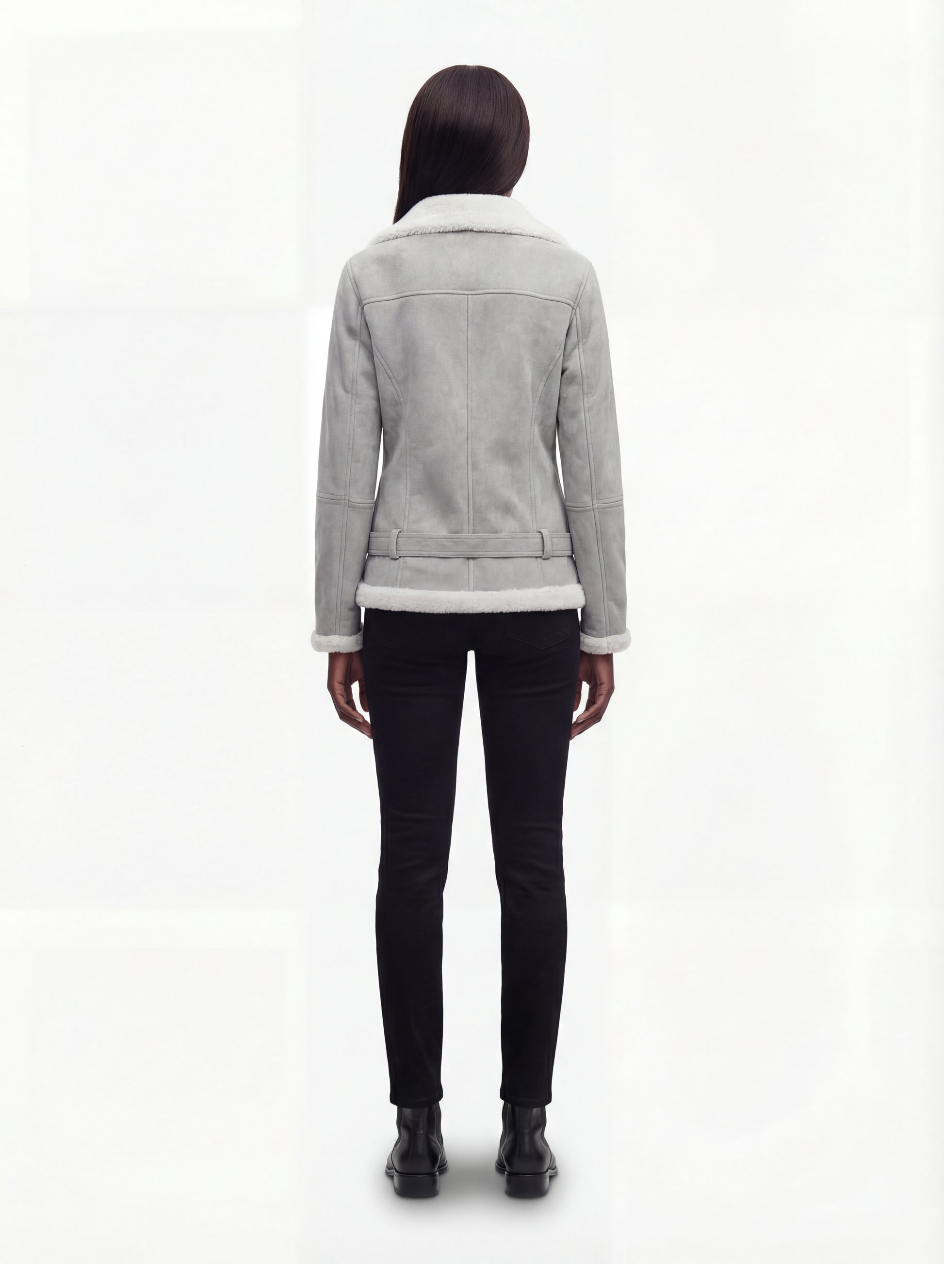 Rear view of female model wearing Maverick Selene biker jacket showing structured shoulder fit and belted waist styling. Maverick Jacket.