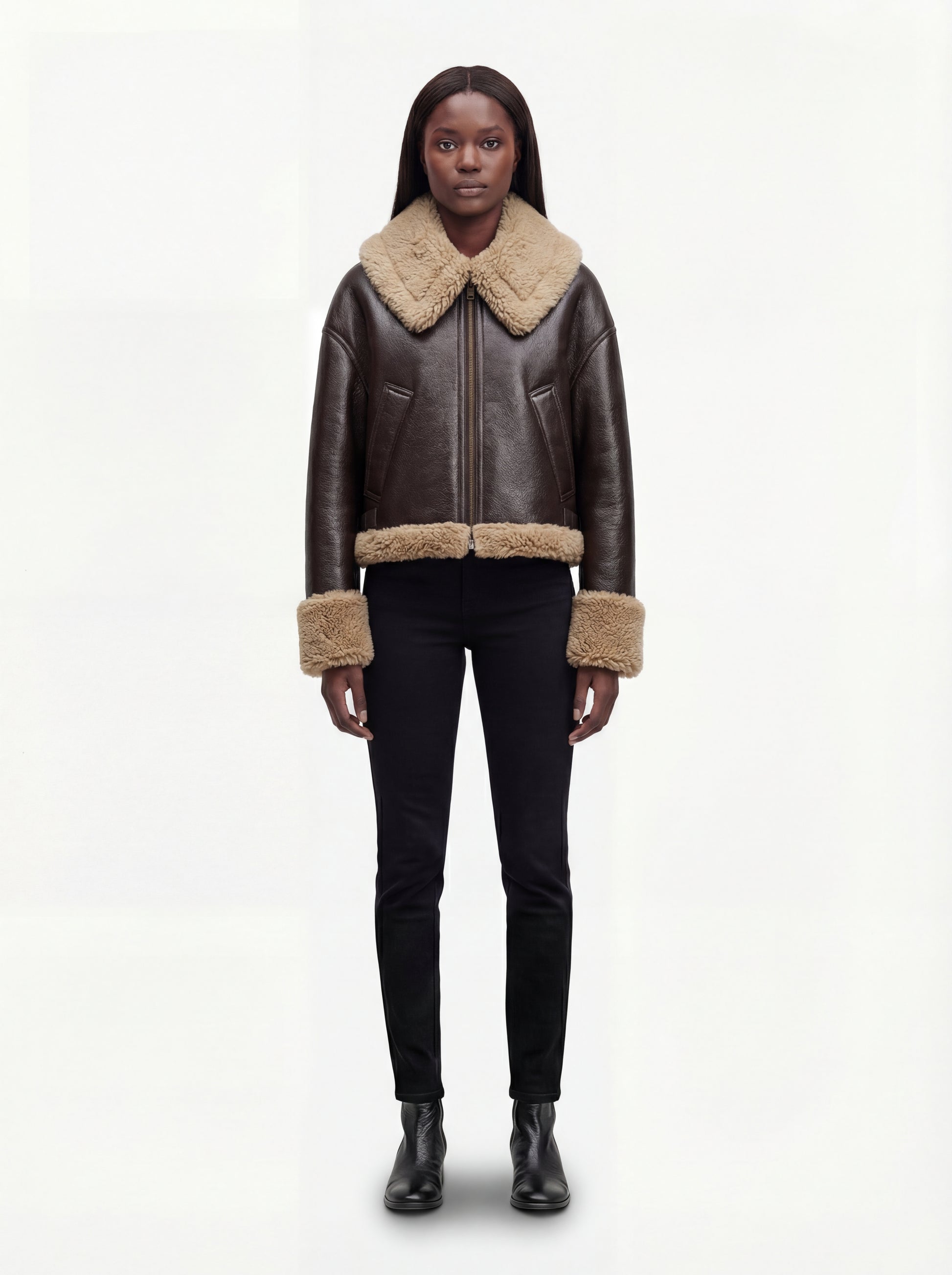 Female model wearing Maverick Faye shearling jacket, boxy fit, styled with black skinny jeans and black leather Chelsea boots. Maverick Faye.