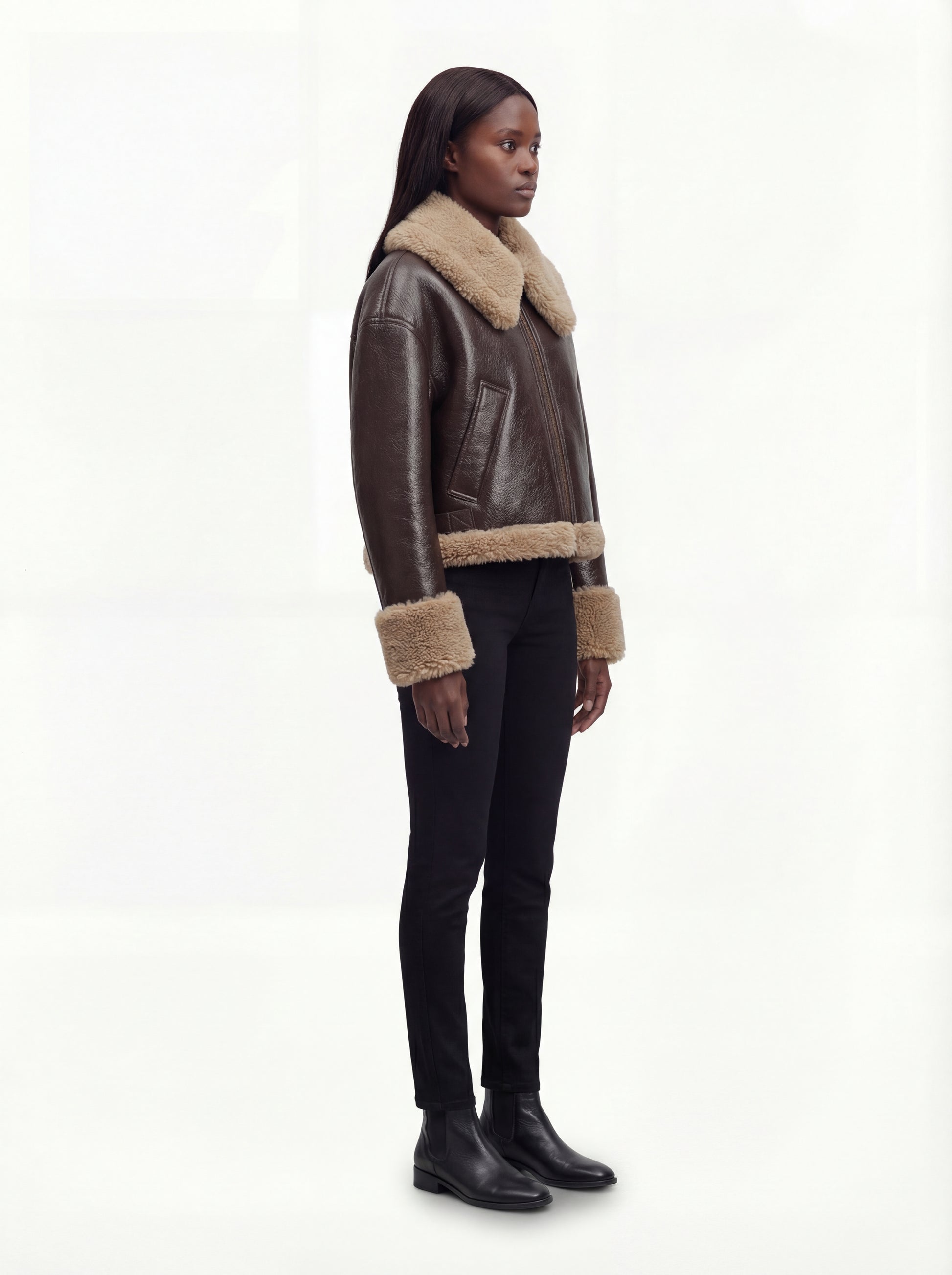 Side profile of Maverick Faye jacket showing shearling cuff detail and boxy hip-length silhouette. Maverick Faye.