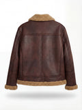 Rear view of brown distressed leather aviator jacket showing vertical center seam and shearling hem trim. Maverick Sierra.