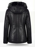 Rear view of black leather shearling coat showing contoured back paneling and hood structure. The Genevieve by Maverick Jacket.
