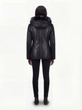 Rear view of female model wearing Maverick Genevieve hooded shearling coat showing fitted shoulder drape and clean back styling. Maverick Jacket.