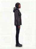 Side profile of Maverick Genevieve shearling coat showing long sleeve structure and mid-length silhouette. Maverick Jacket.