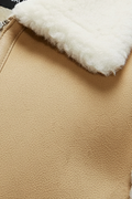 Macro shot of tan nubuck texture and silver zipper hardware near cream wool collar on vest. The Elle by Maverick Jacket.
