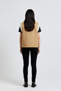 Rear view of female model wearing Maverick Elle shearling vest showing structured shoulder fit and straight back styling. Maverick Jacket.