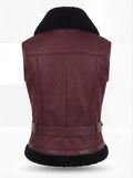 Rear view of burgundy shearling biker vest showing vertical center seam and black fur hem trim. The Valentina by Maverick Jacket.