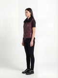 Side profile of Maverick Valentina shearling vest showing sleeveless structure and fitted waist-length silhouette. Maverick Jacket.