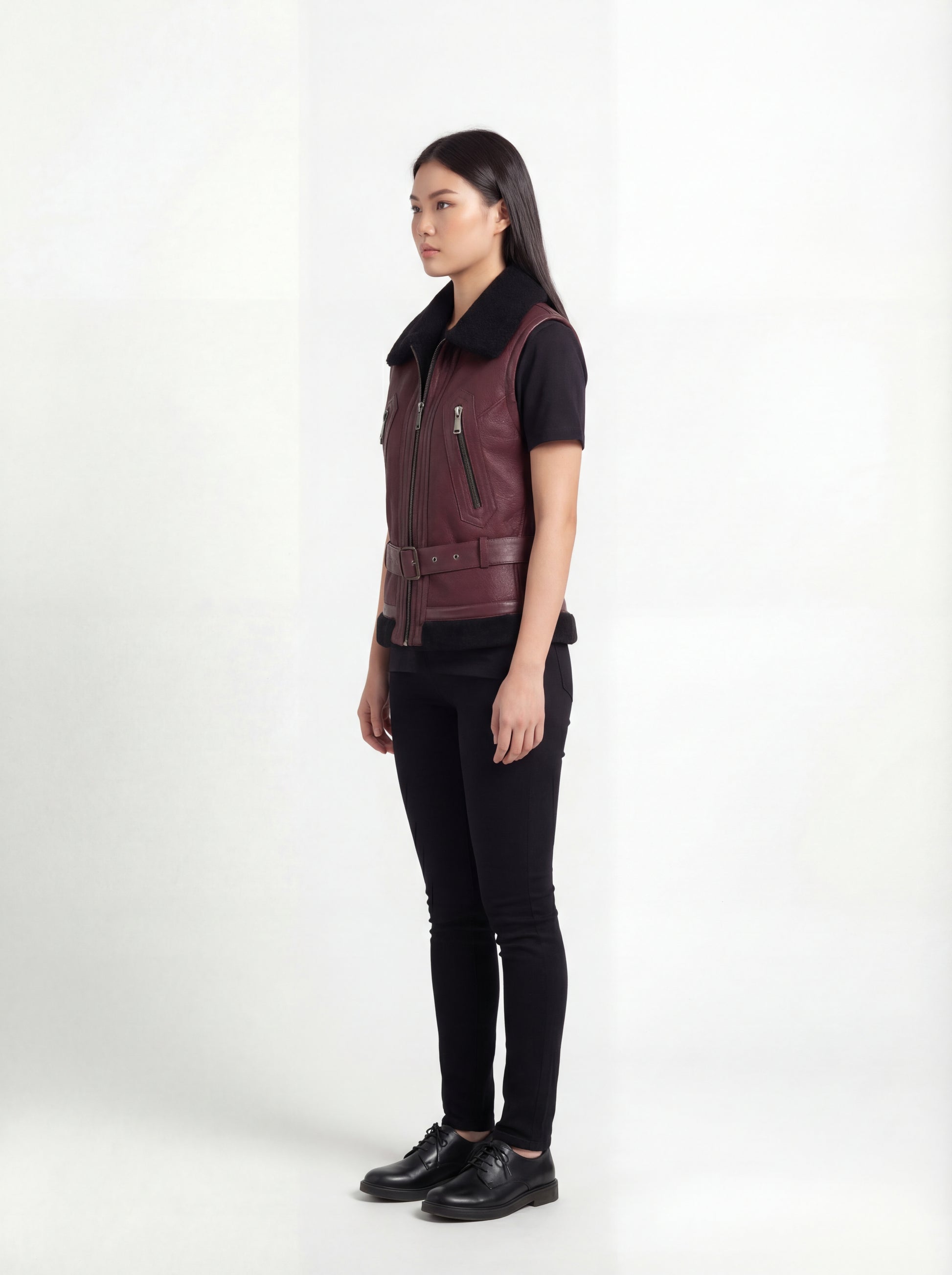 Side profile of Maverick Valentina shearling vest showing sleeveless structure and fitted waist-length silhouette. Maverick Jacket.