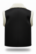 Rear view of black shearling vest showing vertical center seam and cream wool armhole trim. The Elle by  Maverick Jacket.