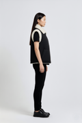 Side profile of Maverick Elle shearling vest showing shearling-trimmed armholes and boxy hip-length silhouette. Maverick Jacket.