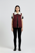 Female model wearing Maverick Elle shearling vest, relaxed fit, styled with black t-shirt and black skinny trousers. Maverick Jacket.