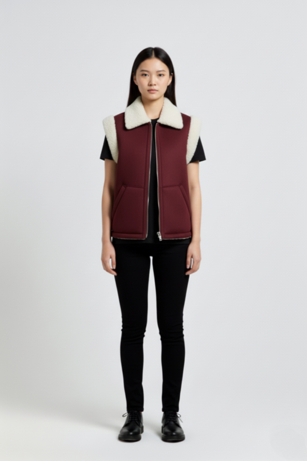 Female model wearing Maverick Elle shearling vest, relaxed fit, styled with black t-shirt and black skinny trousers. Maverick Jacket.