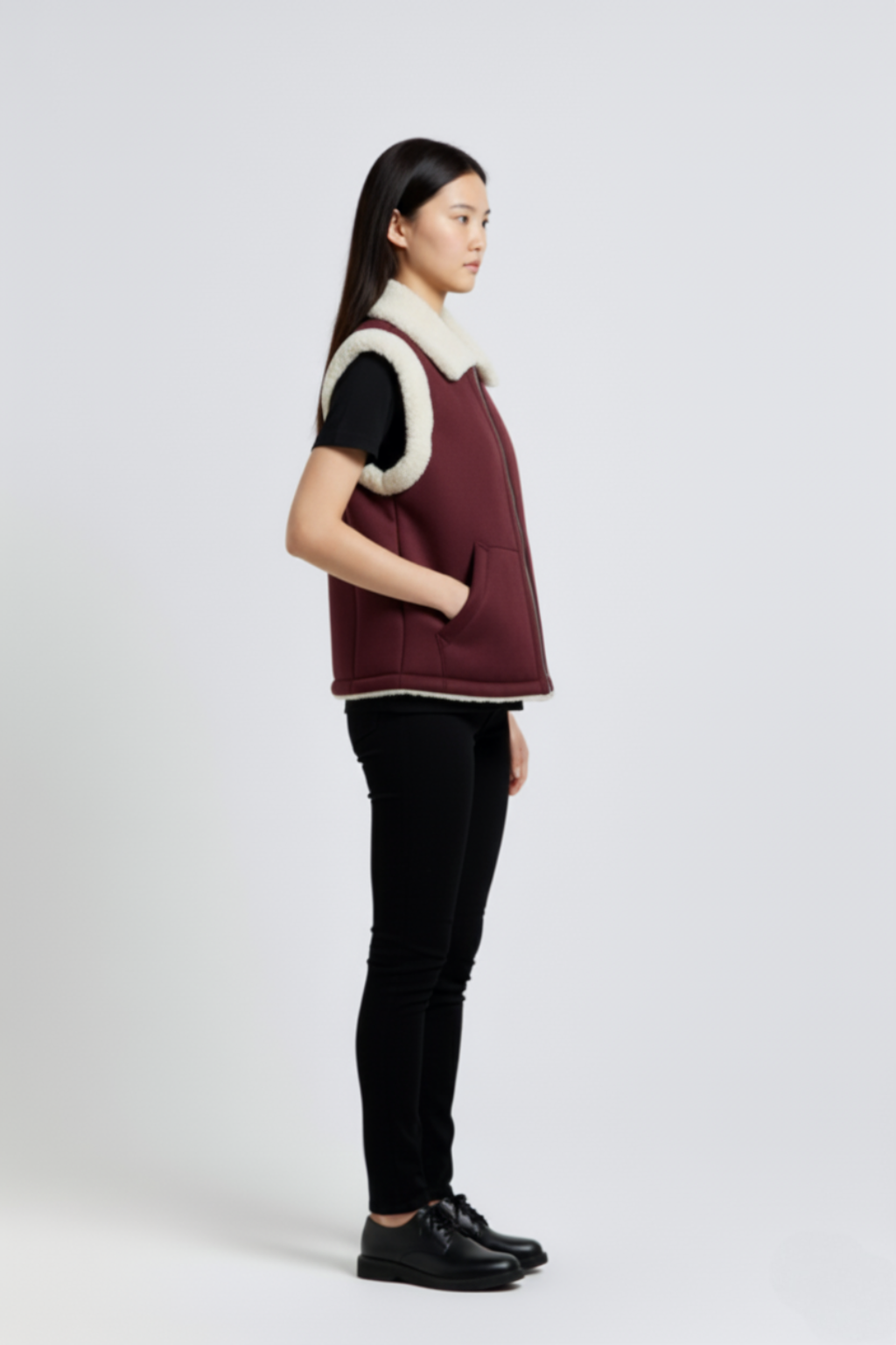 Side profile of Maverick Elle shearling vest showing shearling-trimmed armholes and boxy hip-length silhouette. Maverick Jacket.