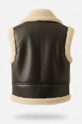 Rear view of black shearling biker vest showing vertical center seam and cream wool hem trim. The Clara by Maverick Jacket.