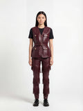 Female model wearing Maverick Victoria burgundy leather utility vest, tailored fit, styled with Maverick Stevie black leather fringe pants. Maverick Jacket.