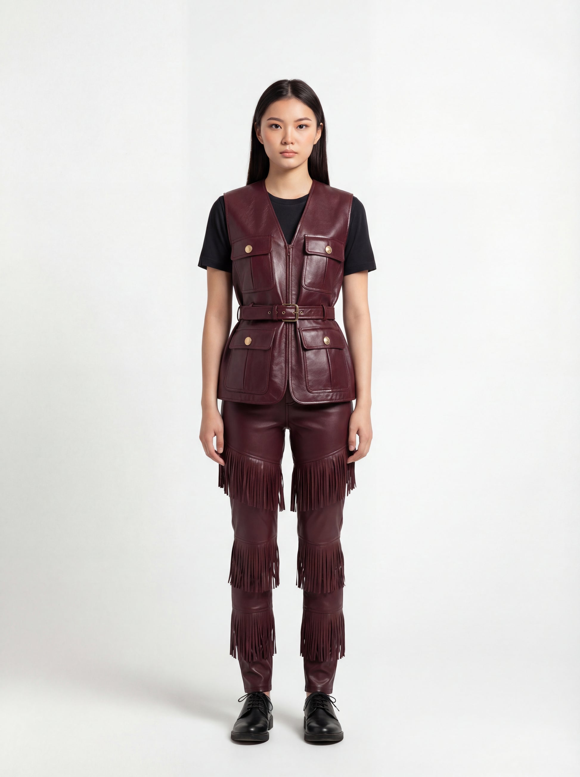 Female model wearing Maverick Victoria burgundy leather utility vest, tailored fit, styled with Maverick Stevie black leather fringe pants. Maverick Jacket.