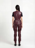 Rear view of female model wearing Maverick Victoria utility vest showing sleek back fit and belted waist styling. Maverick Jacket.
