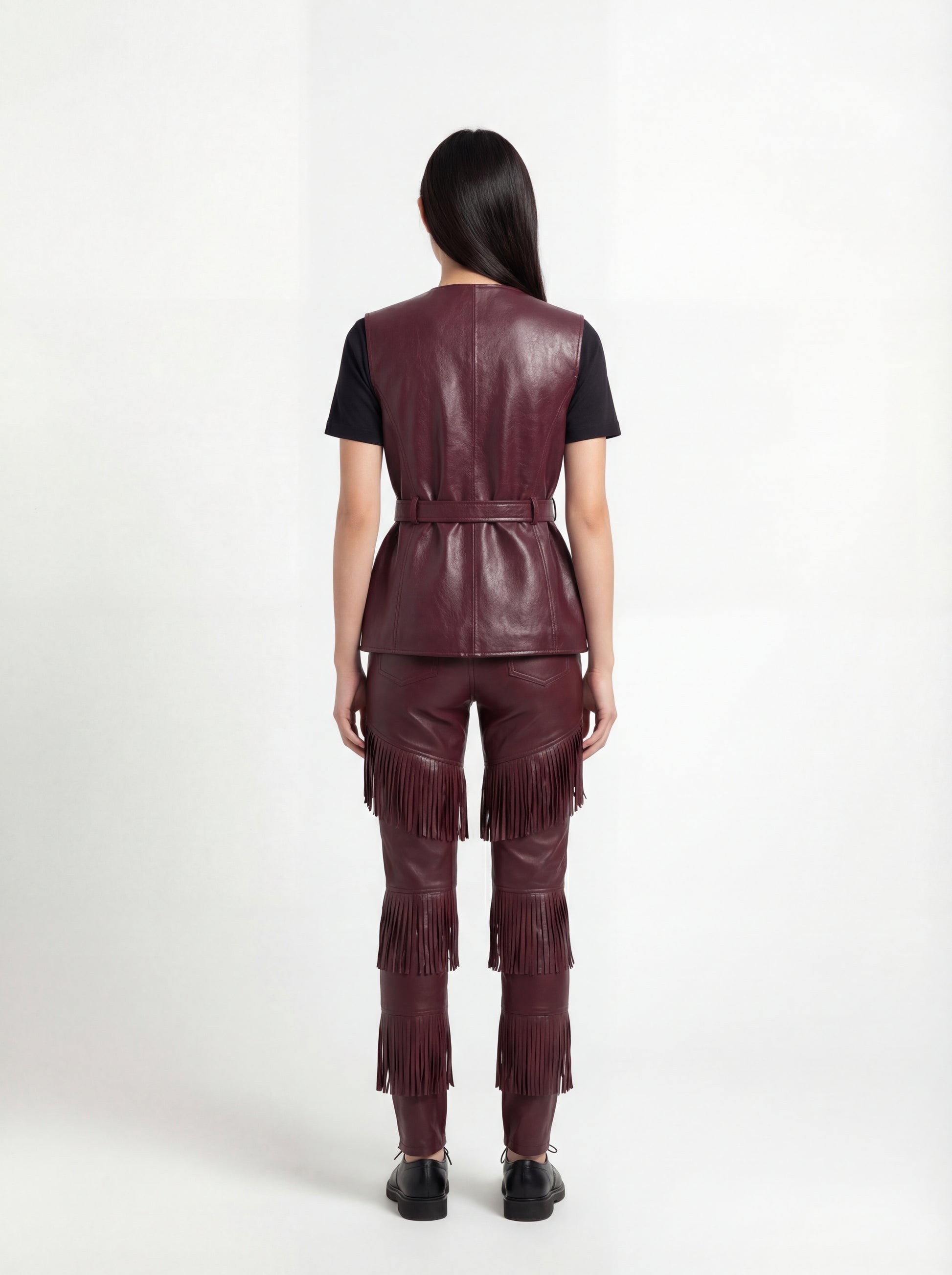 Rear view of female model wearing Maverick Victoria utility vest showing sleek back fit and belted waist styling. Maverick Jacket.
