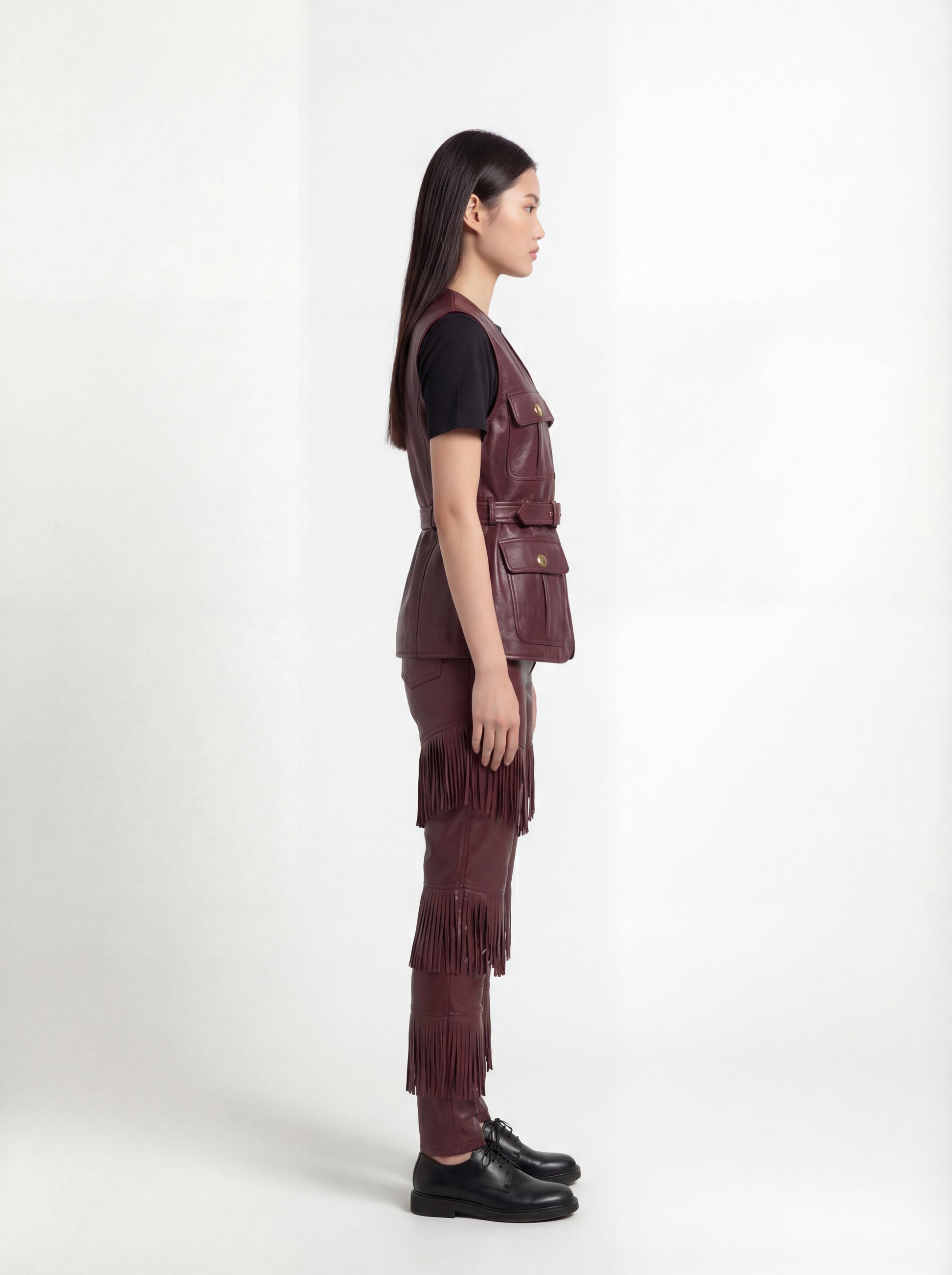 Side profile of Maverick Victoria utility vest showing sleeveless design and structured torso silhouette. Maverick Jacket.