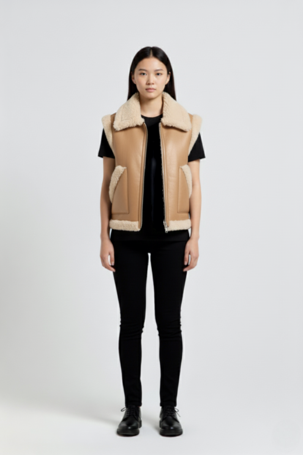Female model wearing Maverick Clara leather vest, relaxed fit, styled with black skinny trousers and black leather derby shoes. Maverick Jacket.