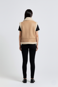 Rear view of female model wearing Maverick Clara leather vest showing structured shoulder fit and straight hem styling. Maverick Jacket.