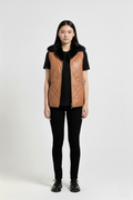 Female model wearing Maverick Isabelle quilted vest, fitted silhouette, styled with black t-shirt and black skinny trousers. Maverick Jacket.