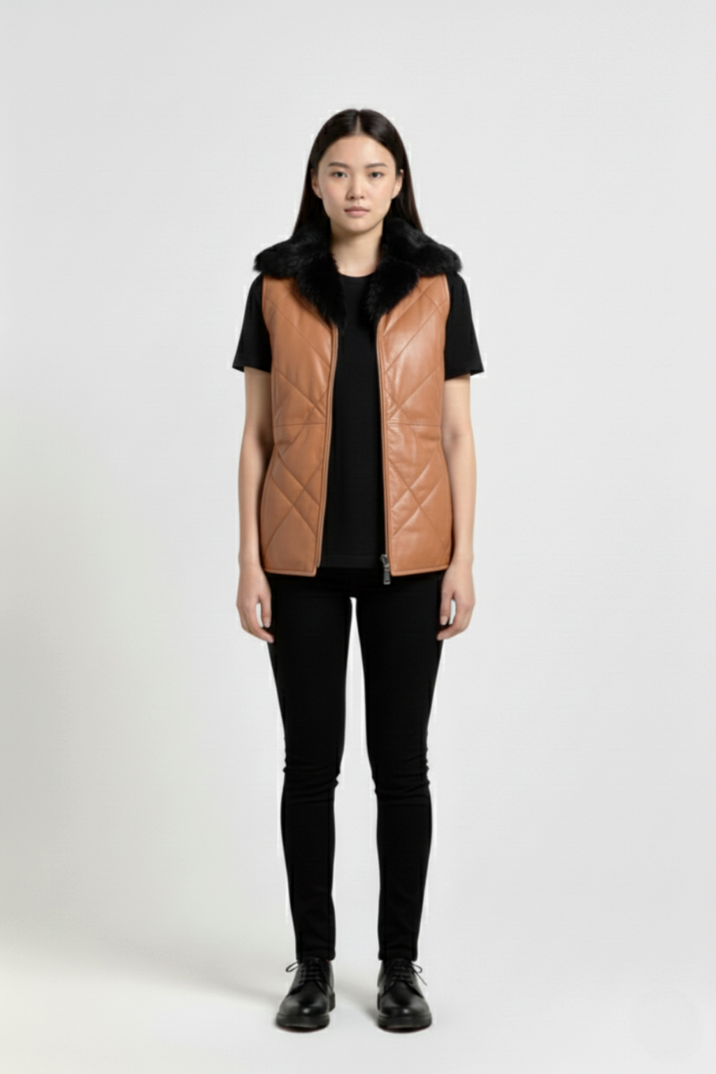 Female model wearing Maverick Isabelle quilted vest, fitted silhouette, styled with black t-shirt and black skinny trousers. Maverick Jacket.