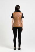 Rear view of female model wearing Maverick Isabelle quilted vest showing tailored waist fit and diamond stitched back styling. Maverick Jacket.