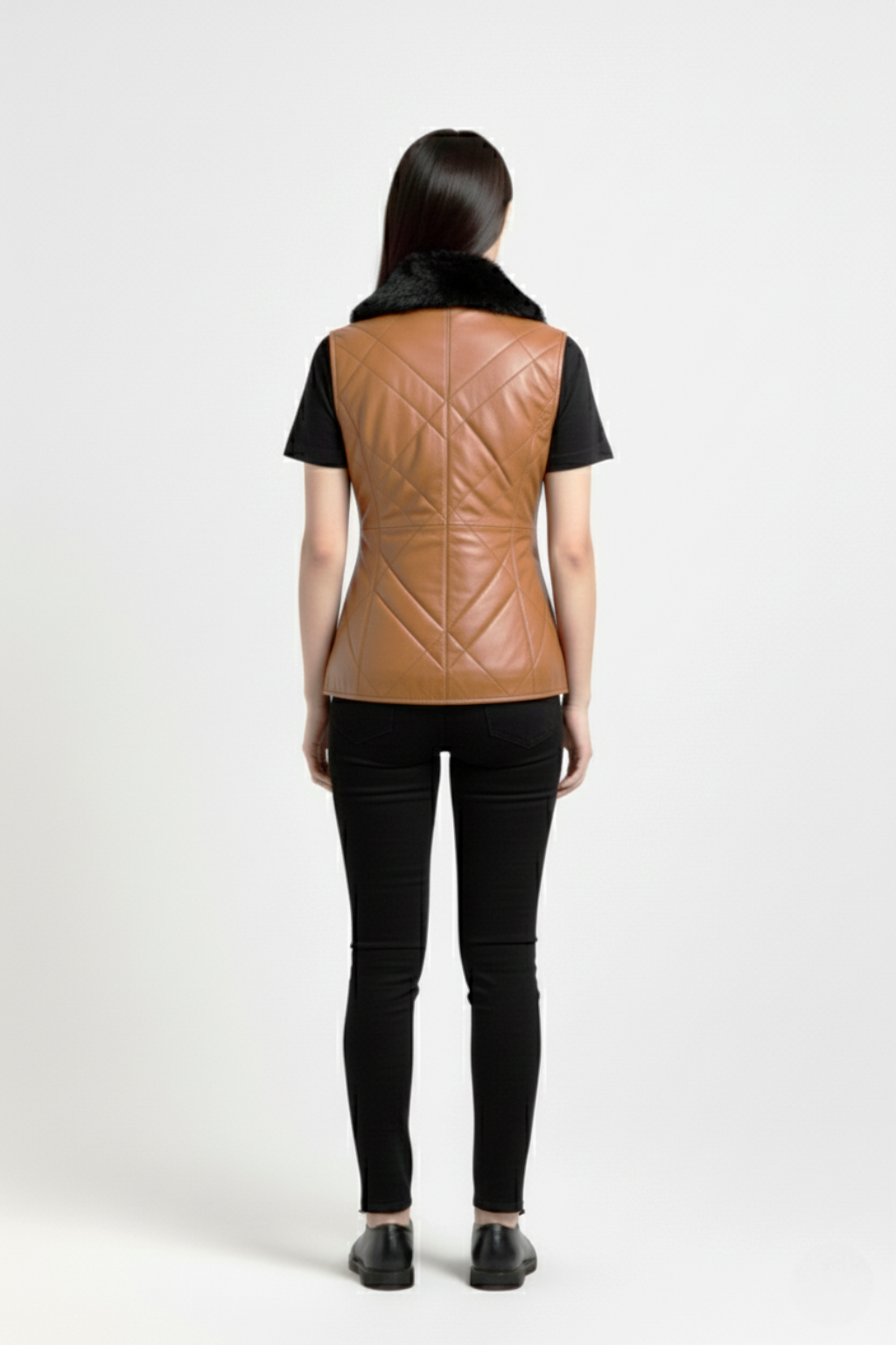 Rear view of female model wearing Maverick Isabelle quilted vest showing tailored waist fit and diamond stitched back styling. Maverick Jacket.