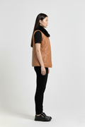 Side profile of Maverick Isabelle quilted vest showing sleeveless armhole cut and slim hip-length silhouette. Maverick Jacket.