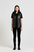 Female model wearing Maverick Isabelle quilted vest, fitted silhouette, styled with black t-shirt and black skinny trousers. Maverick Jacket.