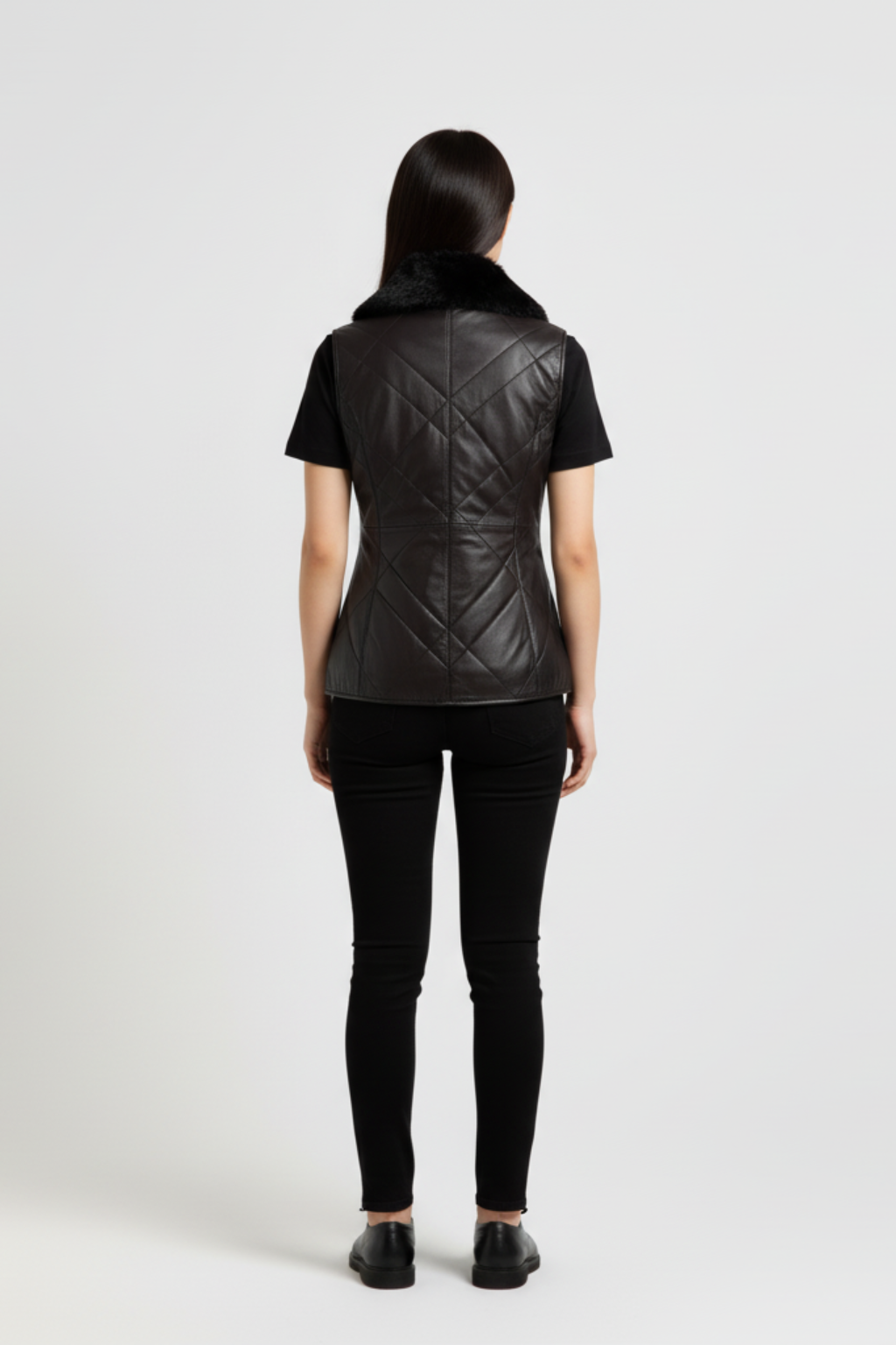 Rear view of female model wearing Maverick Isabelle quilted vest showing tailored waist fit and diamond stitched back styling. Maverick Jacket.